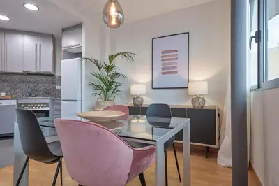 a kitchen and dining room with a table and chairs at SibsBcn Downtown Penthouse in Barcelona