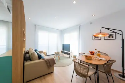 a living room with a couch and a table at Sitges Centre. Simply Charming in Sitges