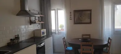 a small kitchen with a table and a microwave at BLAU in Masnou