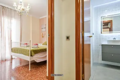a small bedroom with a bed and a bathroom at Alcam Barbera Centro in Barbera del Valles