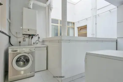 a white laundry room with a washing machine and a sink at Alcam Barbera Centro in Barbera del Valles
