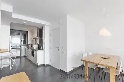 a balcony with a table and a view of the ocean at Santa Romana Apartments & Suites in Caldes d'Estrac