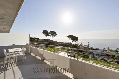 a bedroom with a bed with a view of the ocean at Santa Romana Apartments & Suites in Caldes d'Estrac