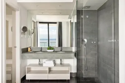 a kitchen and living room with a view of the ocean at Santa Romana Apartments & Suites in Caldes d'Estrac