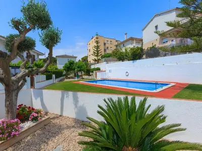 a swimming pool in a yard with trees and plants at Holiday Home Katy by Interhome in Cunit
