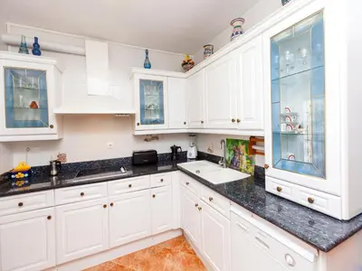 a kitchen with white cabinets and a sink at Holiday Home Katy by Interhome in Cunit