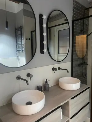 a bathroom with two sinks and two mirrors at OLYMPIC VILLAGE in Barcelona