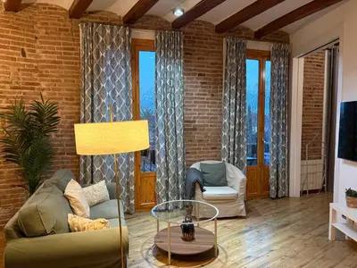 a living room with a couch and a table at OLYMPIC VILLAGE in Barcelona