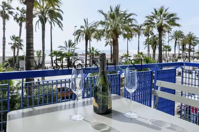 a table with two glasses and a bottle of wine at A 20 metros de la playa in Sitges