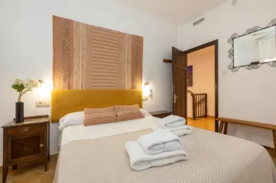 a bedroom with a bed with towels on it at 21 Sleeps Private Pool Villa & BBQ Near Barcelona in Rocafort