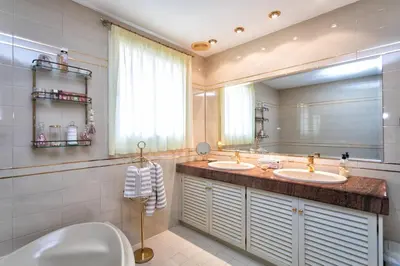 a bathroom with two sinks and a large mirror at Villa Paquita in Calella