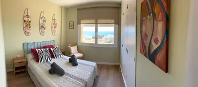 a small bedroom with a bed and a window at APARTAMENTO MARINERO, Vistas impresionantes. in Sitges