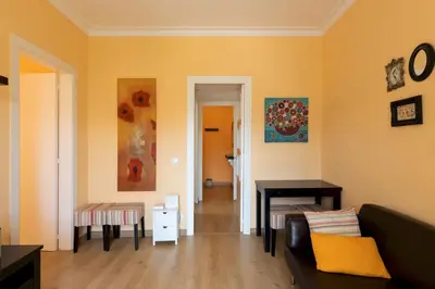 a living room with a couch and a table at Housalia Guell & Gracia in Barcelona