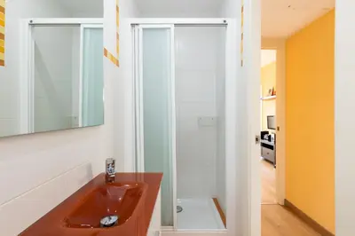 a bathroom with a sink and a mirror at Housalia Guell & Gracia in Barcelona