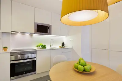 a kitchen with a table with a bowl of fruit on it at Ola Living Calabria in Barcelona