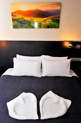 a bedroom with a bed with two white pillows at 6 Bis HOTEL in Castelldefels