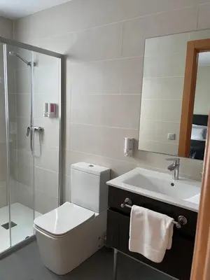 a bathroom with a toilet and a sink and a shower at 6 Bis HOTEL in Castelldefels