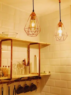 two lights hanging above a shelf in a kitchen at Arena Gold Euroviajeros apartaments in Pineda de Mar