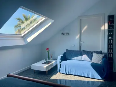 a living room with a bed and a window at Palm Maresme - Suite with bathroom and terrasse with ocean views in a private villa in Vilassar de Dalt