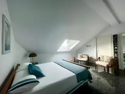 a bedroom with a large bed in a attic at Palm Maresme - Suite with bathroom and terrasse with ocean views in a private villa in Vilassar de Dalt