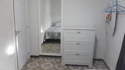a bedroom with a white dresser and a bed at loft turistic in San Vicente dels Horts