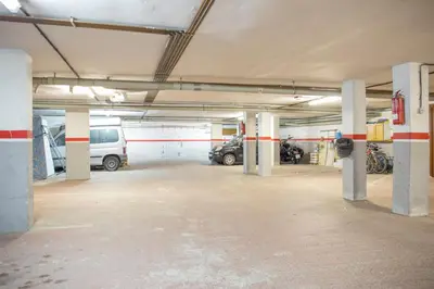 an empty parking garage with cars parked in it at CUNIT HOME in Cunit