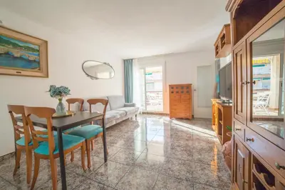 a living room with a table and chairs and a couch at CUNIT HOME in Cunit