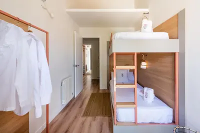 a room with bunk beds and a hallway at Petit Luxe Tobella Dreta in Terrassa