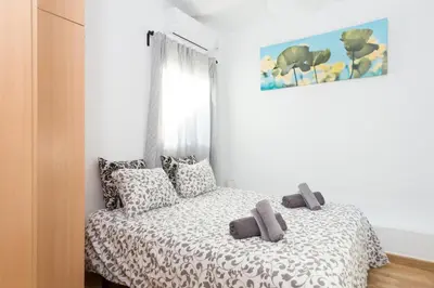 a bedroom with a bed with two gray towels on it at Key Sagrada Familia / MARINA 223 in Barcelona