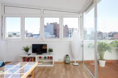 a living room with a tv and some windows at Key Sagrada Familia / MARINA 223 in Barcelona
