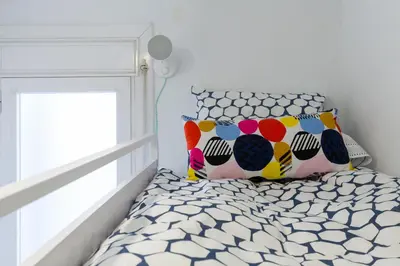 a bedroom with a bed with a pillow and a window at Key Sagrada Familia / MARINA 223 in Barcelona