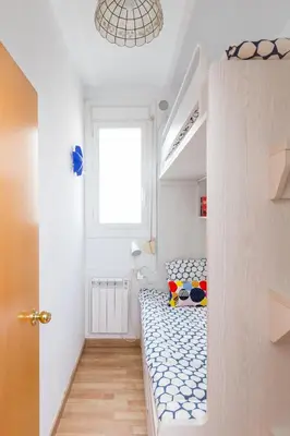 a bedroom with a bed in a room with a window at Key Sagrada Familia / MARINA 223 in Barcelona