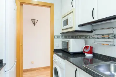 a kitchen with a sink and a microwave at Key Sagrada Familia / MARINA 223 in Barcelona