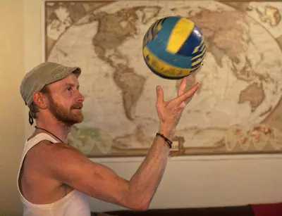a man is playing with a volley ball at Pars Tailor's Hostel in Barcelona