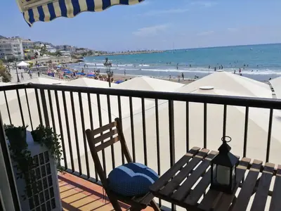 a balcony with a bench and a view of the beach at Port alegre - en el corazón de Sitges in Sitges