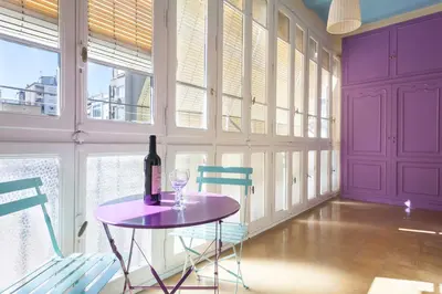 a purple room with a table and two chairs at Apartments Barcelona & Home Deco Eixample in Barcelona