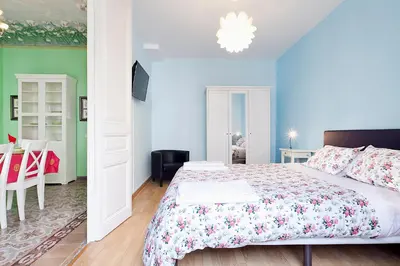 a bedroom with a bed and a dining room at Apartments Barcelona & Home Deco Eixample in Barcelona