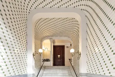 a hallway with a stairway with a door and a wall at Apartments Barcelona & Home Deco Eixample in Barcelona
