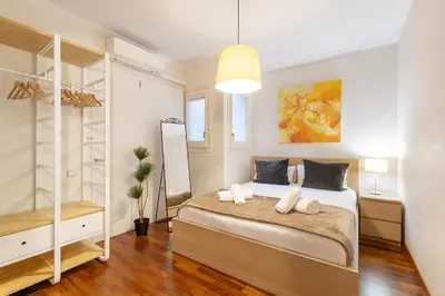 a bedroom with a large bed and a closet at Large & beautiful apartment 4min from Passeig de Gràcia in Barcelona