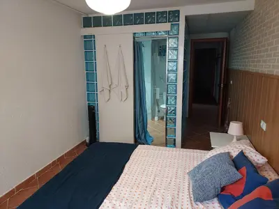 a bedroom with a bed and a large mirror at Barcelona Village Homestay in Tiana