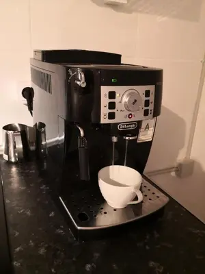 a coffee maker with a bowl on a counter at Barcelona Village Homestay in Tiana