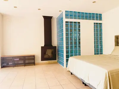 a bedroom with a bed and a fireplace at Barcelona Village Homestay in Tiana