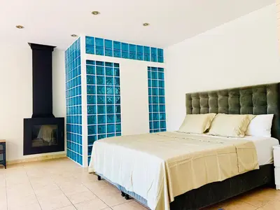 a bedroom with a large bed and a fireplace at Barcelona Village Homestay in Tiana