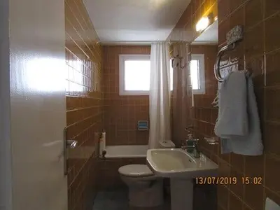 a bathroom with a toilet and a sink at Apart.con piscina en Sitges zona residencial in Sitges