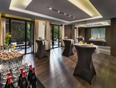 a dining room with wine bottles and tables at H10 Urquinaona Plaza in Barcelona