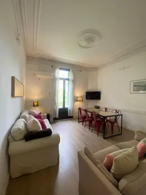 a living room with two couches and a table at 555 Apartments BCN in Barcelona