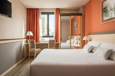 a hotel room with a bed and a desk at Petit Palace Trencadís in Barcelona