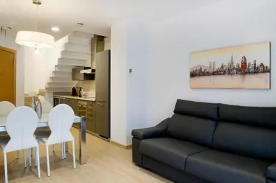 a living room with a couch and a table and chairs at Home to Home Barcelona in Barcelona