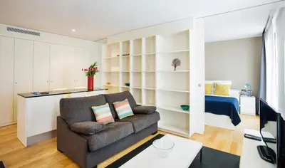 a living room with a couch and a bedroom at Durlet Beach Apartments in Barcelona