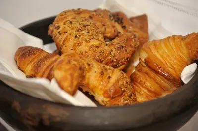a bowl filled with pastries and croissants at The 8 Boutique B&B in Barcelona